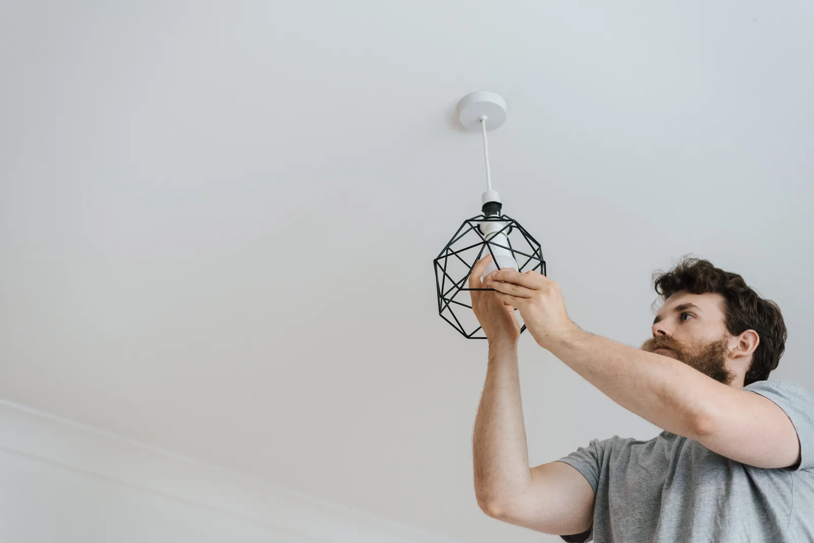 Fitting a lamp into a pendant fixture, for ev charger installation in Windsor